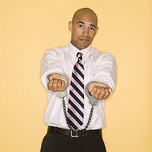Man wearing handcuffs and looking sad