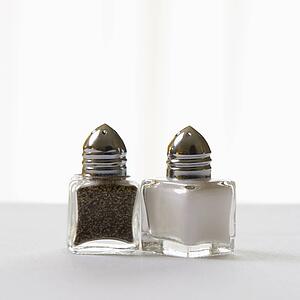 Matching salt and pepper shakers on white