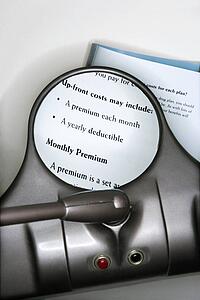 Vision magnifying glass used to view health insurance information
