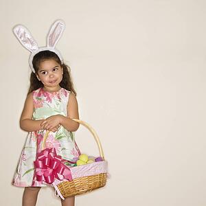 Girl wearing bunny ears holding Easter basket