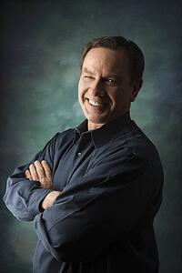 Smiling man with arms crossed