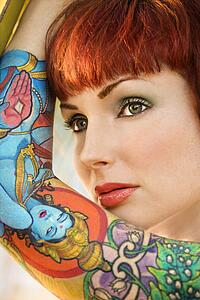 Close up portrait of attractive tattooed Caucasian woman 