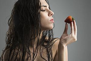 Woman holding strawberry