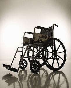 Empty silhouetted wheelchair.