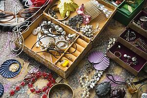 Open jewelry box sitting on top of dresser