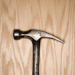 Metal hammer on wood