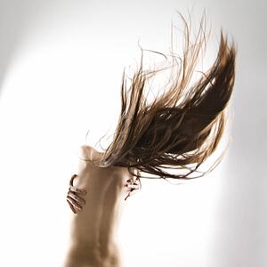 Topless woman swinging her hair