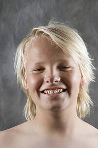 Male Caucasian adolescent portrait smiling.