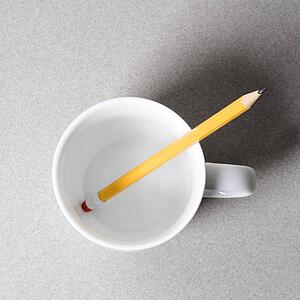High angle view of a pencil in an empty white coffee cup.