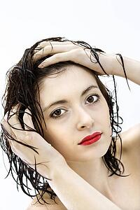 Portrait of attractive young woman redhead with wet hair.