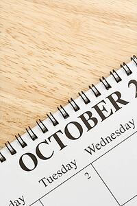 Close up of spiral bound calendar displaying month of October