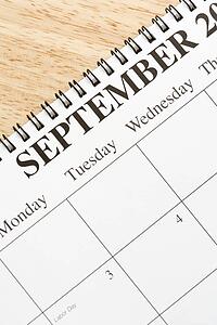 Close up of spiral bound calendar displaying month of September