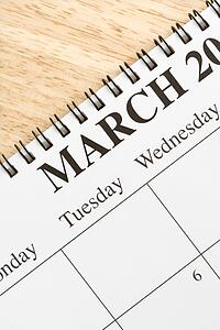 Close up of spiral bound calendar displaying month of March