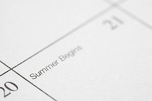 Close up of calendar displaying the beginning of summer