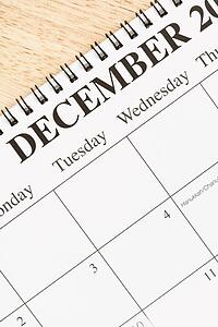 Close up of spiral bound calendar displaying month of December