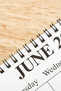Close up of spiral bound calendar displaying month of June