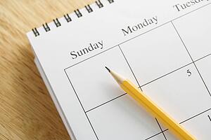 Pencil on top of a spiral bound calendar