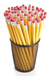 Group of pencils in a pencil holder with eraser ends up