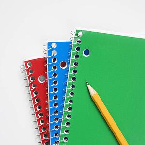 Pencil on top of three spiral bound notebooks