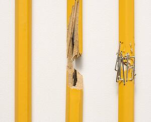 Whole pencil, broken pencil and stapled together pencil lined up against white background