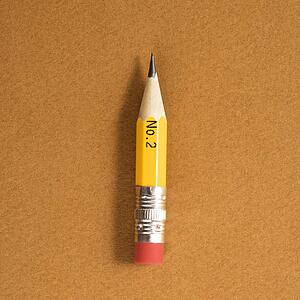 Short number two pencil on tan background
