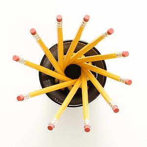 Top view of group of pencils in pencil holder arranged in a spiral shape