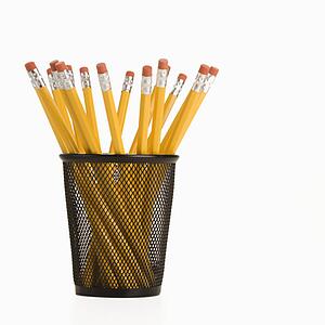 Group of pencils in a pencil holder with eraser ends up