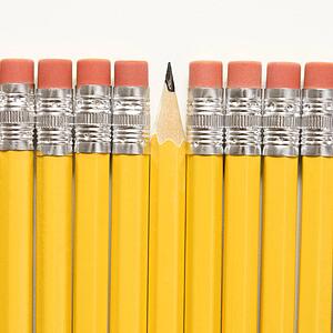 Even row of eraser ends of pencils except for one that has the pointed end up.