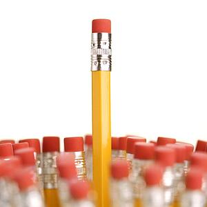 Group of eraser ends of pencils with one standing out higher than the rest
