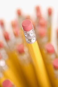 Group of eraser ends of pencils with one standing out higher than the rest