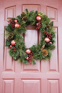 Christmas wreath hanging on door.