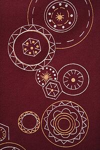 Close-up of maroon vintage fabric with white and yellow lines and shapes printed on polyester