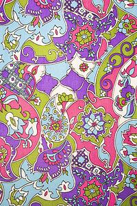 Close-up of colorful vintage fabric with flowers and shapes printed on polyester