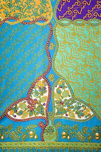Close-up of colorful vintage fabric with abstract blue and turquoise shapes printed on polyester