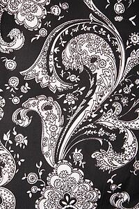 Close-up of black and white vintage fabric with flowers and paisley printed on polyester