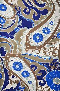 Close-up of colorful vintage fabric with blue and brown paisley printed on polyester