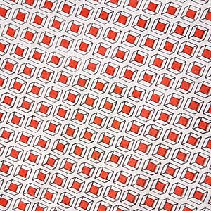 Close-up of vintage fabric with repetitive red cube designs printed on polyester