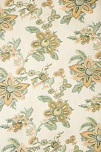 Close-up of vintage fabric with golden flowers and green leaves printed on polyester