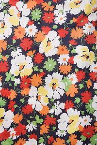 Close-up of vintage fabric with colorful flowers printed on polyester