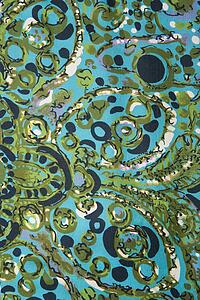 Close-up of colorful vintage fabric with abstract blue and turquoise shapes printed on silk