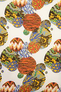 Close-up of colorful vintage fabric with orbs of abstract designs printed on polyester