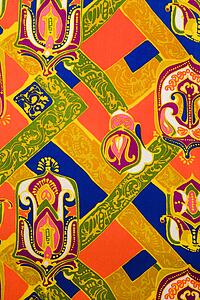 Close-up of colorful vintage fabric with bright shapes printed on polyester