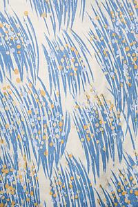 Close-up of vintage fabric with abstract blue and yellow brushstrokes printed on polyester