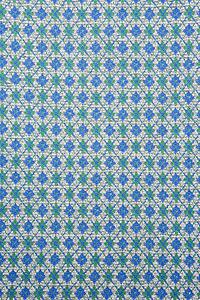 Close-up of woven vintage fabric with repetitive blue and green diamonds