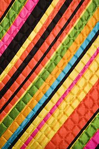 Close-up of bright colorful striped quilted vintage fabric