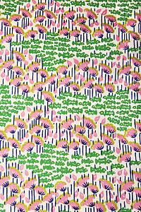 Close-up of vintage fabric with pink flowers and green fish printed on polyester