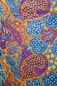 Close-up of colorful vintage fabric with flowers and shapes printed on polyester