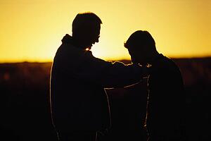 Silhouette of a father and son