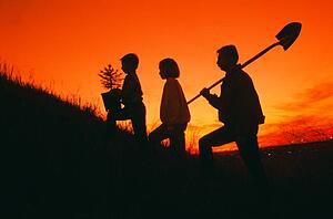 Silhouette of family going to plant a tree