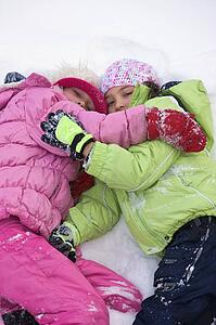 Friends lying in the snow 